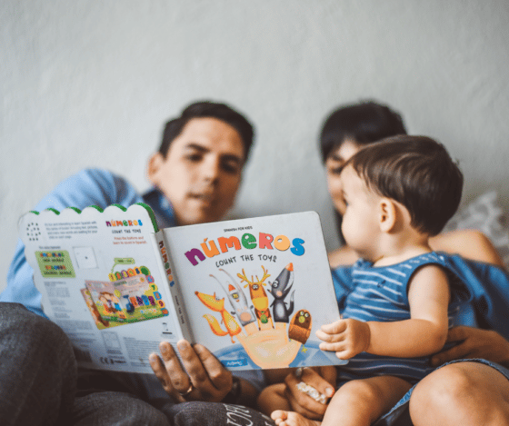 parents reading to infant