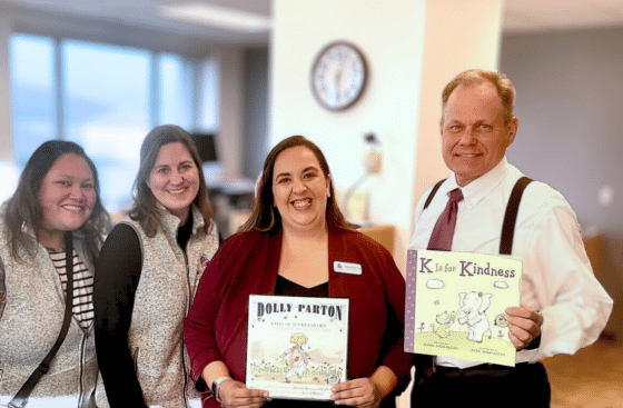 Mayor Bronson poses with 3 Best Beginnings staff and Imagination Library books