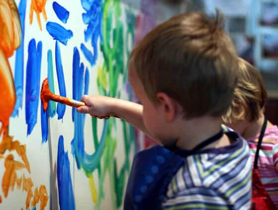 Preschool child paints